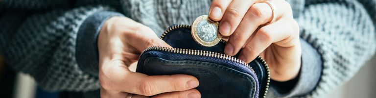Person putting a coin into a coin purse