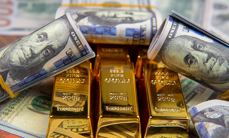 Gold bars and American currency close up
